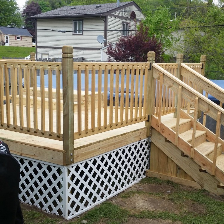 Custom wooden deck with railings and stairs, showcasing craftsmanship and attention to detail, designed for outdoor living in Northern Indiana.