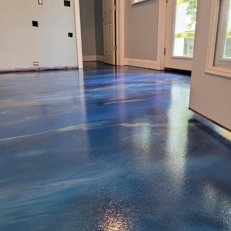 Luxury blue epoxy flooring showcasing a glossy finish in a residential space, emphasizing high-performance materials and craftsmanship by Forge Construction & Design.